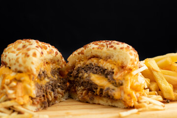 Burger cheese with potato in wooden table and black backgournd 