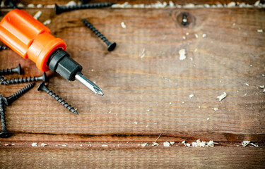 Screwdriver with a bunch of self-tapping screws. 