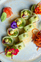 Healthy pine sushi stuffed with vegetables and cream cheese with quinoa topping