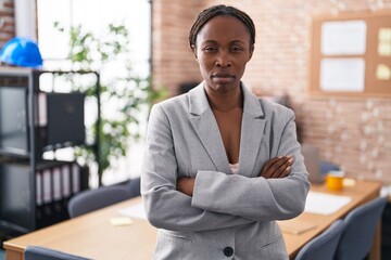 African american woman at the office skeptic and nervous, disapproving expression on face with crossed arms. negative person.