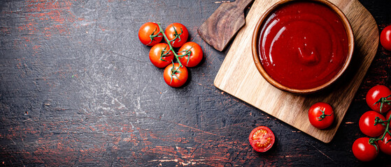 Tomato sauce on a wooden cutting board. 