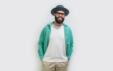 Young bearded hipster guy wearing white blank t shirt with copy space for your text or logo. Mockup for design
