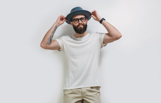 Young Bearded Hipster Guy Wearing White Blank T Shirt With Copy Space For Your Text Or Logo. Mockup For Design