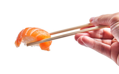  Hand of man holding salmon nigiri with chopsticks over isolated white background