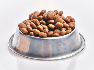  Delicious bowl of dog food balls over isolated white background