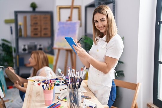 Mother and daughter artists using touchpad drawing at art studio