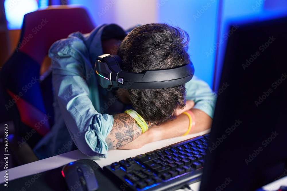 Sticker Young hispanic man streamer stressed using computer at gaming room