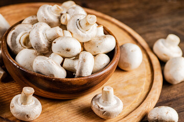 Mushrooms in a bowl on a cutting board. 