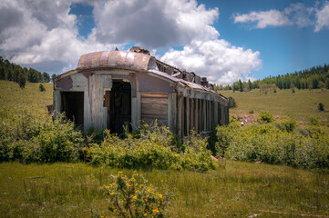 Abandoned train diner car near the mountains