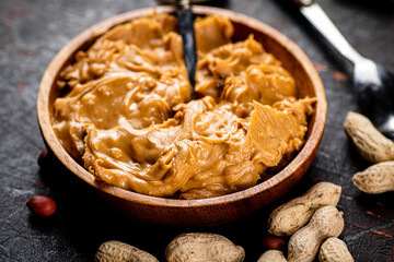 Peanut butter on a plate with a spoon. 