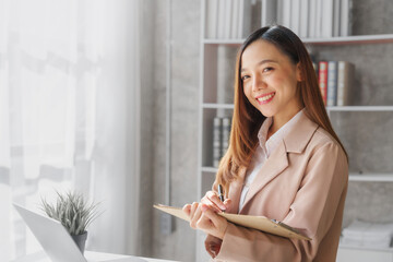 Young asia pretty entrepreneur busy woman in her private office working audit and calculating expense financial annual financial report balance sheet statement, checking inspection tax calculation