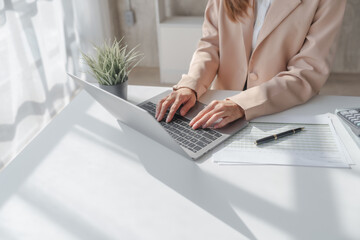 Close up entrepreneur busy woman in her private office working audit and calculating expense financial annual financial report balance sheet statement, checking inspection tax calculation