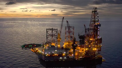 Aerial view of offshore jack up drilling rig during sunset - oil and gas industry
 - Powered by Adobe