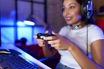 Young arab woman streamer playing video game using joystick at gaming room © Krakenimages.com