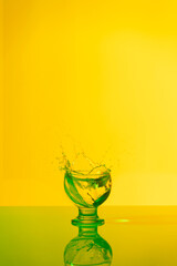 Explosion of drinks in a very nice wayBeverage explosion with yellow and green lights in studio