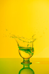 Explosion of drinks in a very nice wayBeverage explosion with yellow and green lights in studio