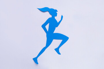 Fototapeta na wymiar Woman`s health. Paper female figure running on white background, top view