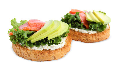Tasty rusks with salmon, cream cheese and avocado isolated on white