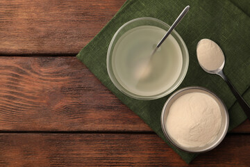 Agar-agar jelly and powder on wooden table, flat lay. Space for text