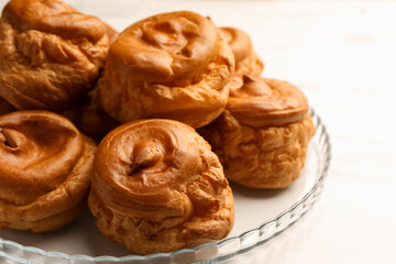 Delicious profiteroles on white table, closeup view