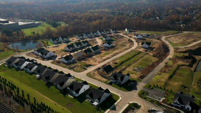 Aerial view of a new construction neighborhood with various single-family homes in different stages of completion