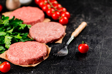 Raw burger with tomatoes and parsley. 