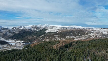 Fototapeta na wymiar Snowdonia, Wales (UK), Winter 2023. Aerial landscapes of snow and mountains.