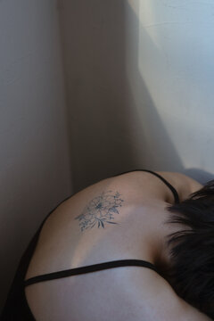 Portrait of asian woman with tattoo on back