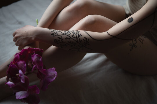 Magenta flower and tattoo on arms