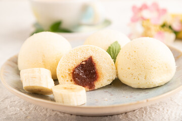 Japanese rice sweet buns mochi filled with jam on a gray concrete. side view, selective focus.
