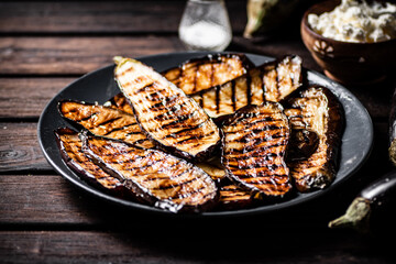 A plate with grilled pieces of eggplant. 