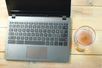 a pint of beer from above next to a laptop