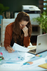 business owner woman in green office working with documents