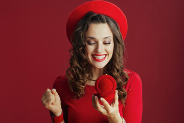 happy elegant woman in dress and beret with jewellery box