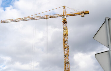 Construction site with cranes against blue sky. Industrial background. Modern skyscrapers. Unfinished construction