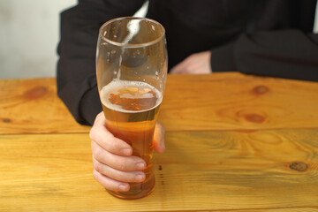 mug with beer in hand on the table