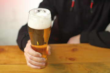 mug with beer in hand on the table