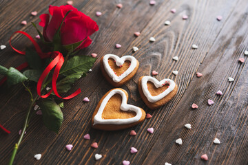 Red rose with postcard on wooden background. Happy Valentines Day postcard. Love concept for mothers day or valentines day. Valentine card with space for text