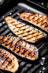 Slices of eggplant in a grill pan. 