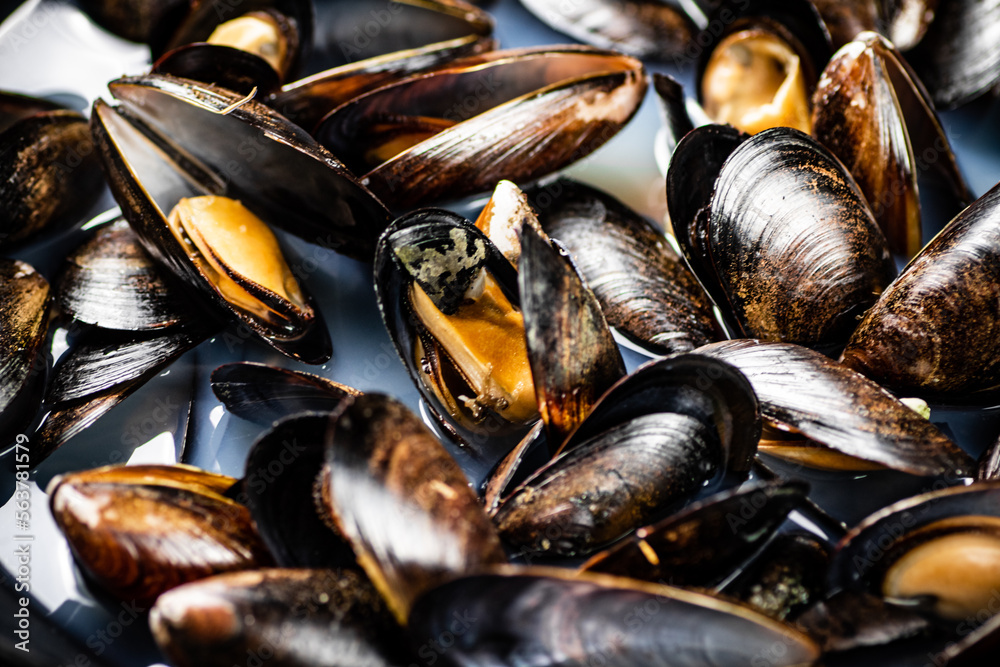 Sticker delicious mussels are boiled in a pot of water.