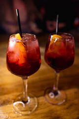 Two glasses with beautiful alcoholic cocktails on the bar counter in a nightclub, bar
