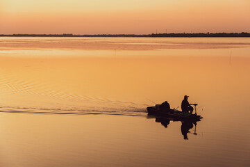 Fototapeta na wymiar Fisherman's boat on the river with sunset.