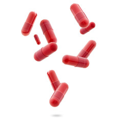 red medical gel capsules falling down on white background. food supplement, pharmacy concept. plastick capsules pills