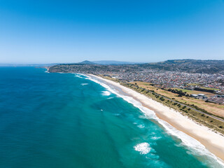 Fototapeta na wymiar High angle aerial drone view of Lawyers Head Beach, Saint Kilda Beach and Saint Clair Beach (one continuous beach) in Dunedin, the second-largest city in the South Island of New Zealand.