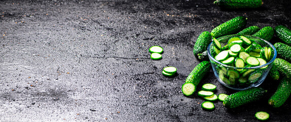 Full glass bowl of chopped fresh cucumbers. 
