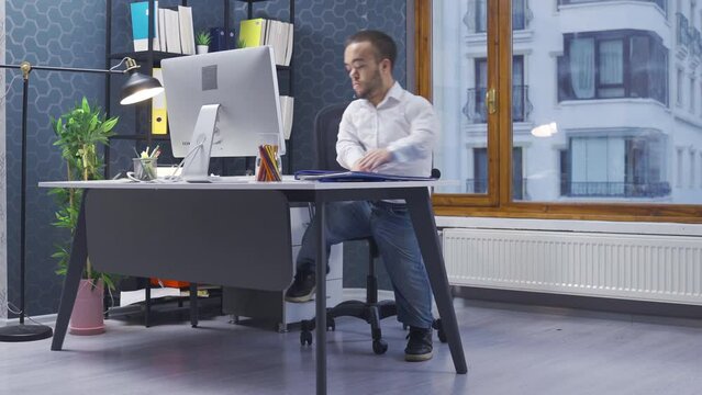 Home office worker dwarf man. Disabled midget man works in his home office. Comes with the file and sits down.
