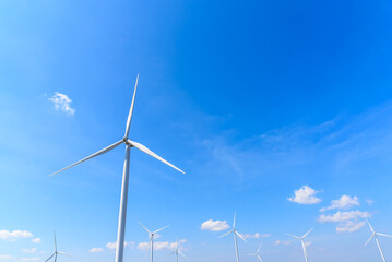 Fototapeta premium Windmills for clean electric power production. Windmill wind turbine for eco energy green and clean energy environment concervation climate change concept.