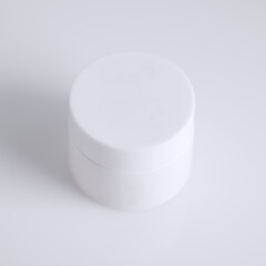 white jar of a cosmetic beauty cream isolated on white background with an open cap