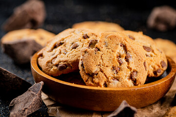Delicious cookies with pieces of milk chocolate on a plate.
