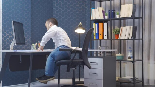 Disabled dwarf man in a rush for work rejoices. He's an office worker. The disabled dwarf man, who comes running to his office, looks at his computer and is happy.

